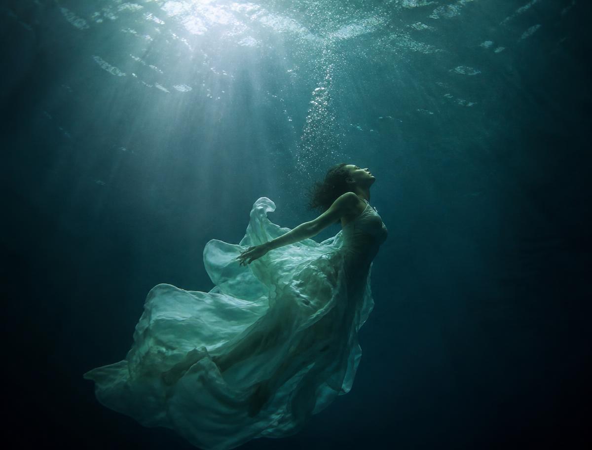 Silk gown suspended in deep water